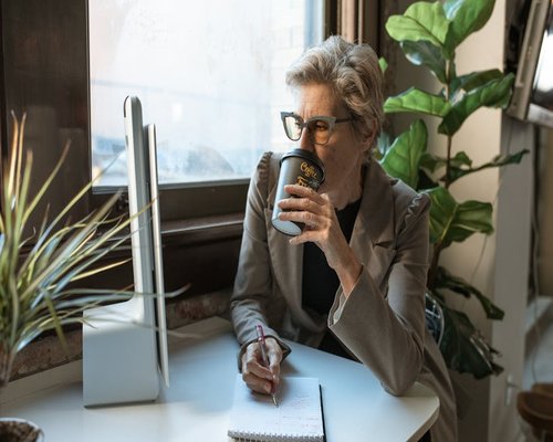 Person taking a screen break by a window with natural light